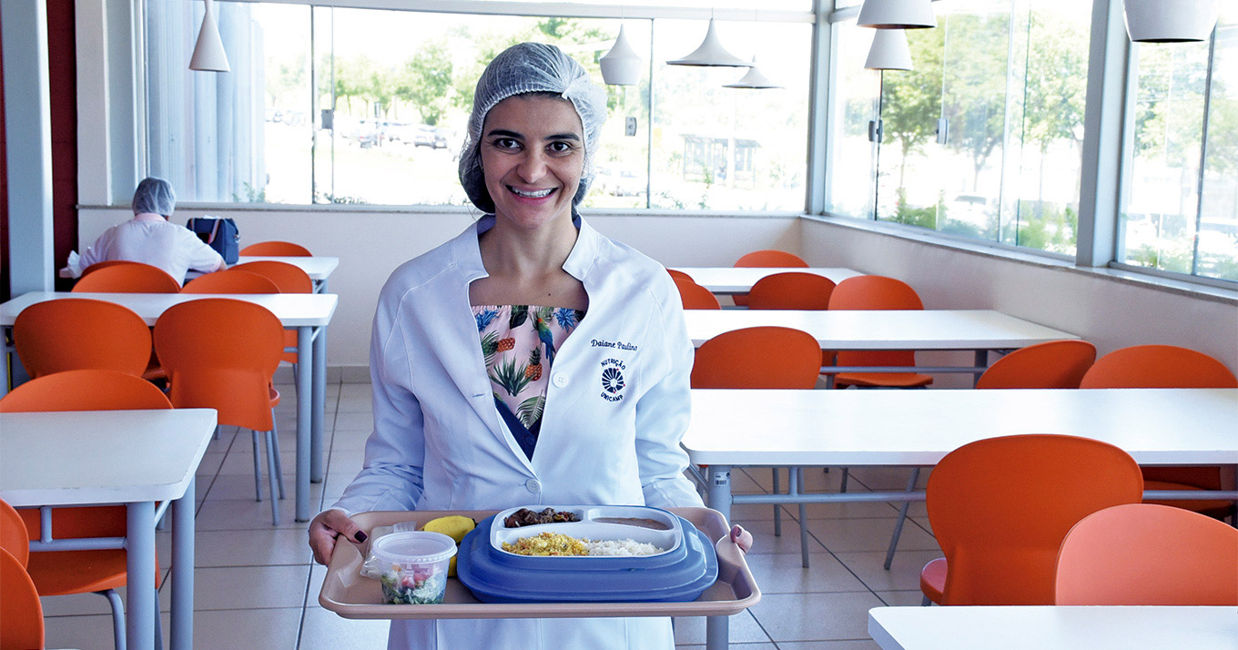 Daiane Paulino, funcionária do setor de Nutrição do Caism, com refeição destinada a uma gestante